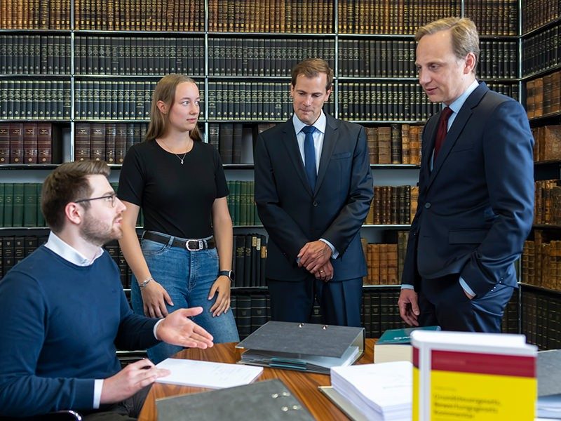 Die Rechtsanwälte und Steuerberater Sascha Fehsenfeld (zweiter von rechts) und Bastian Ruge (rechts) im Gespräch mit ihrem Team